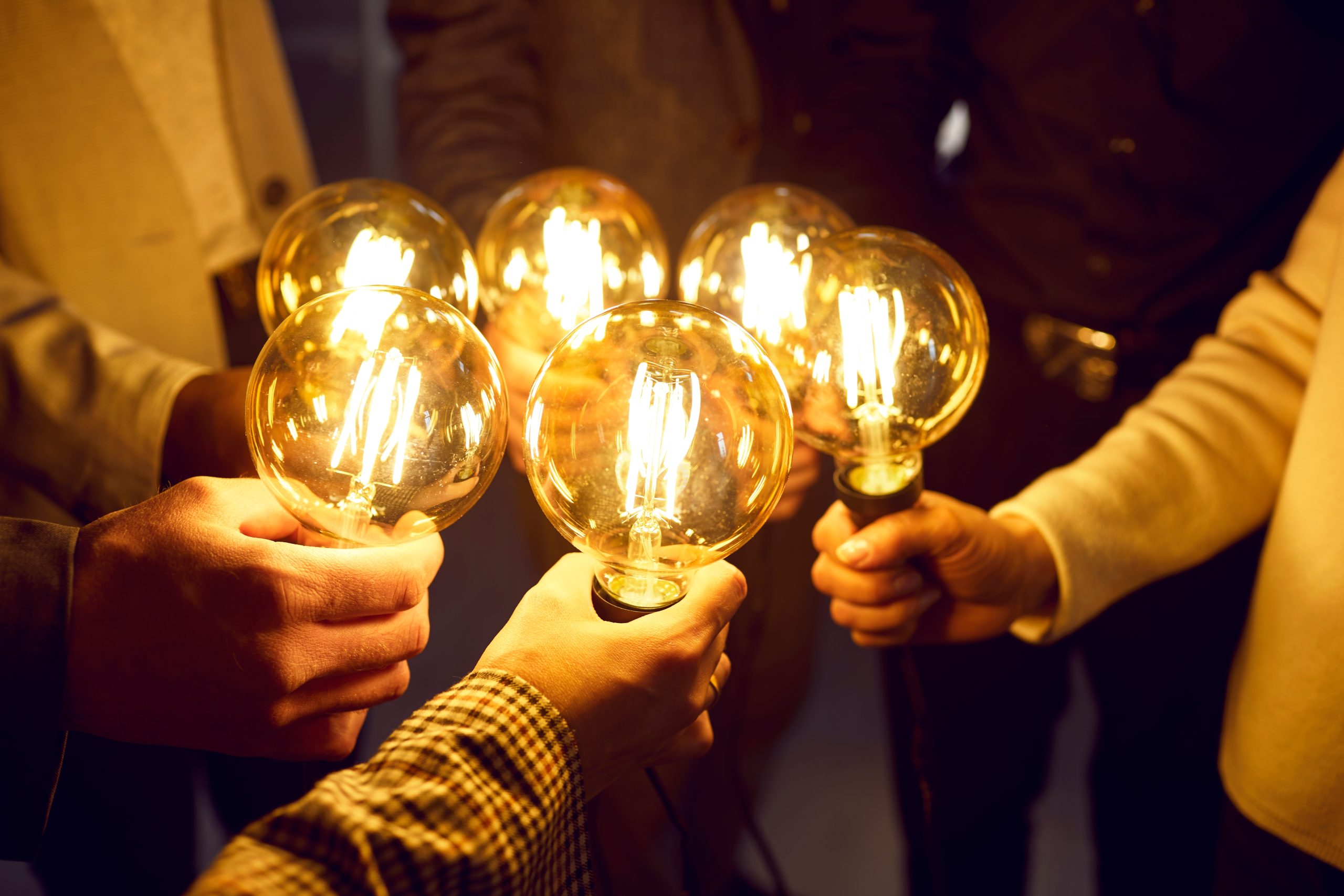 Group holding light bulbs